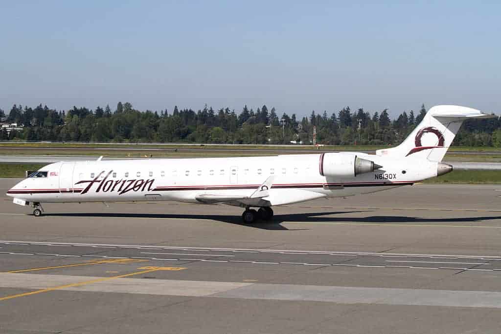 Horizon Air plane on the runway in clear blue skies