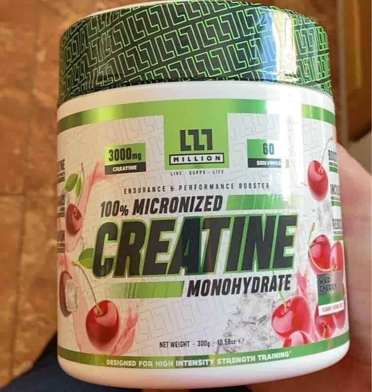 a man holding a container of creatine