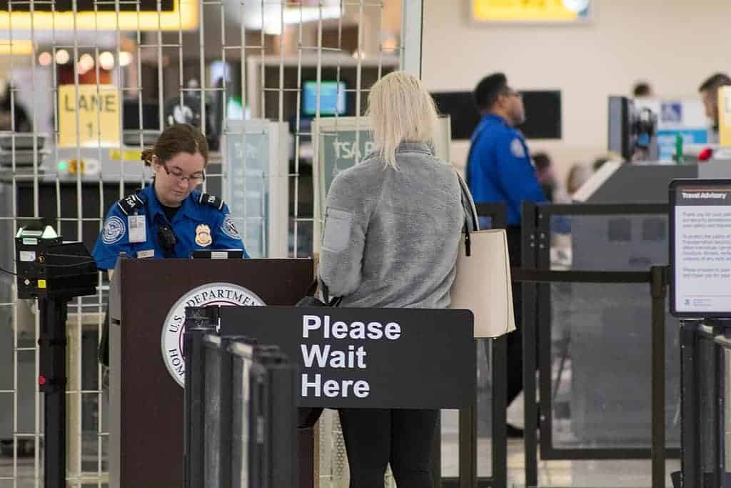 Woman waiting at a TSA checkpoint to be inspected