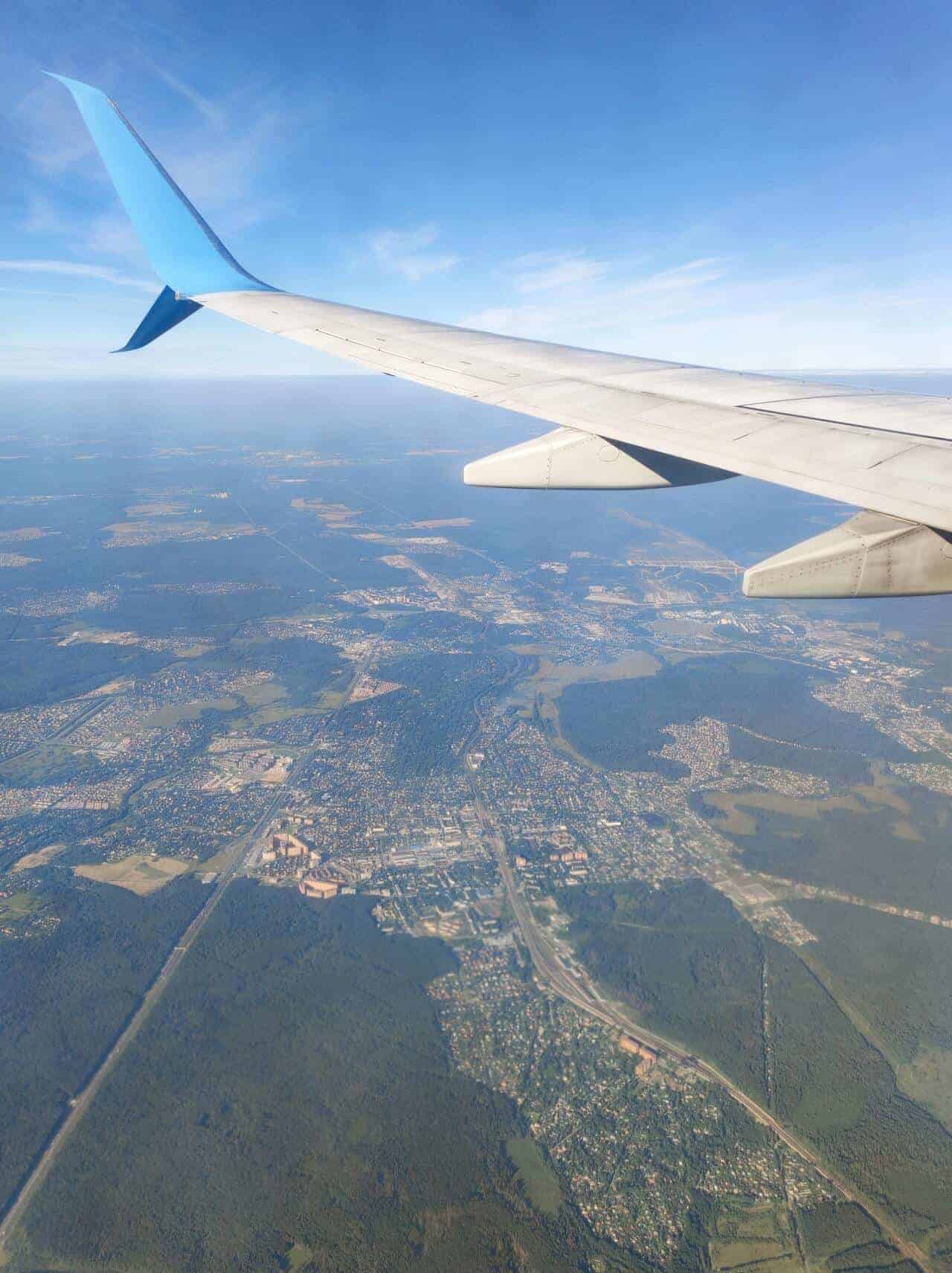 View of a plane's wing and land at 20,000 feet