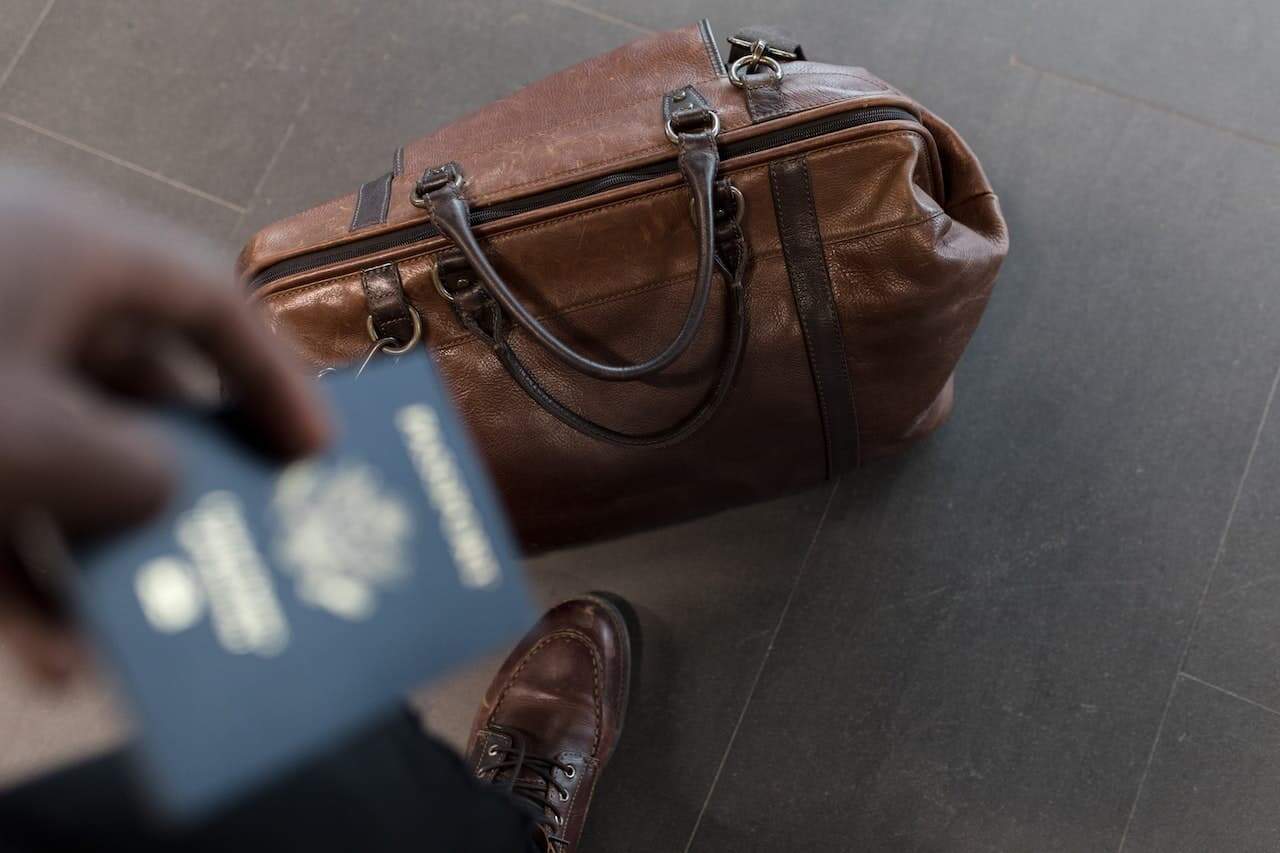 man holding a U.S. passport that is blurred