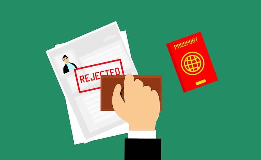 A man stamping a travel insurance claim with rejected