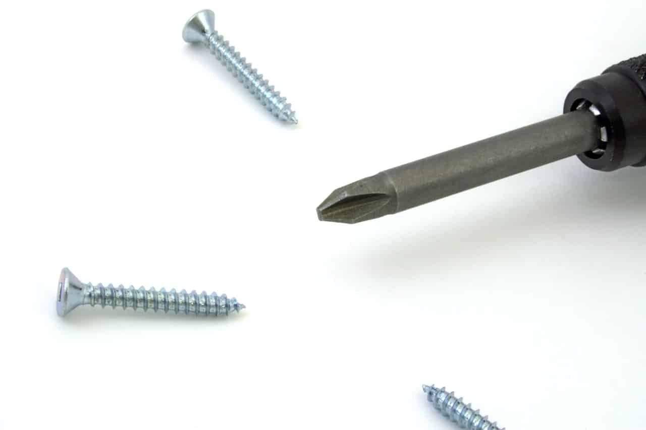 a screwdriver surrounded by 3 screws