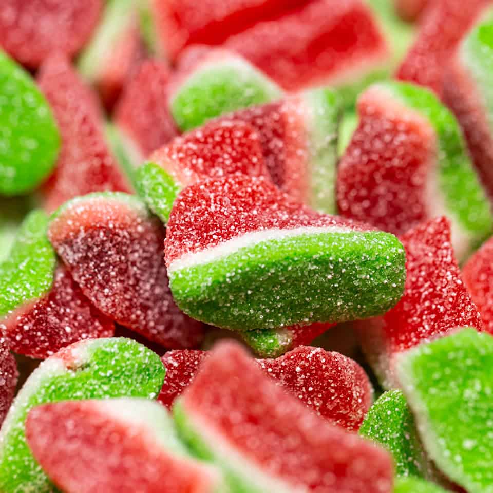 Texture background with watermelon shaped jelly candies.