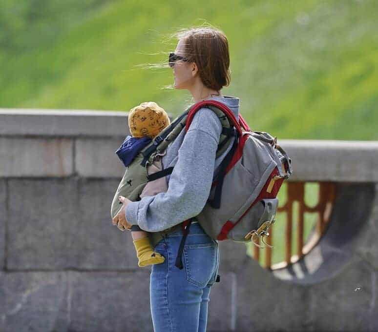 woman carrying her child in a baby carrier