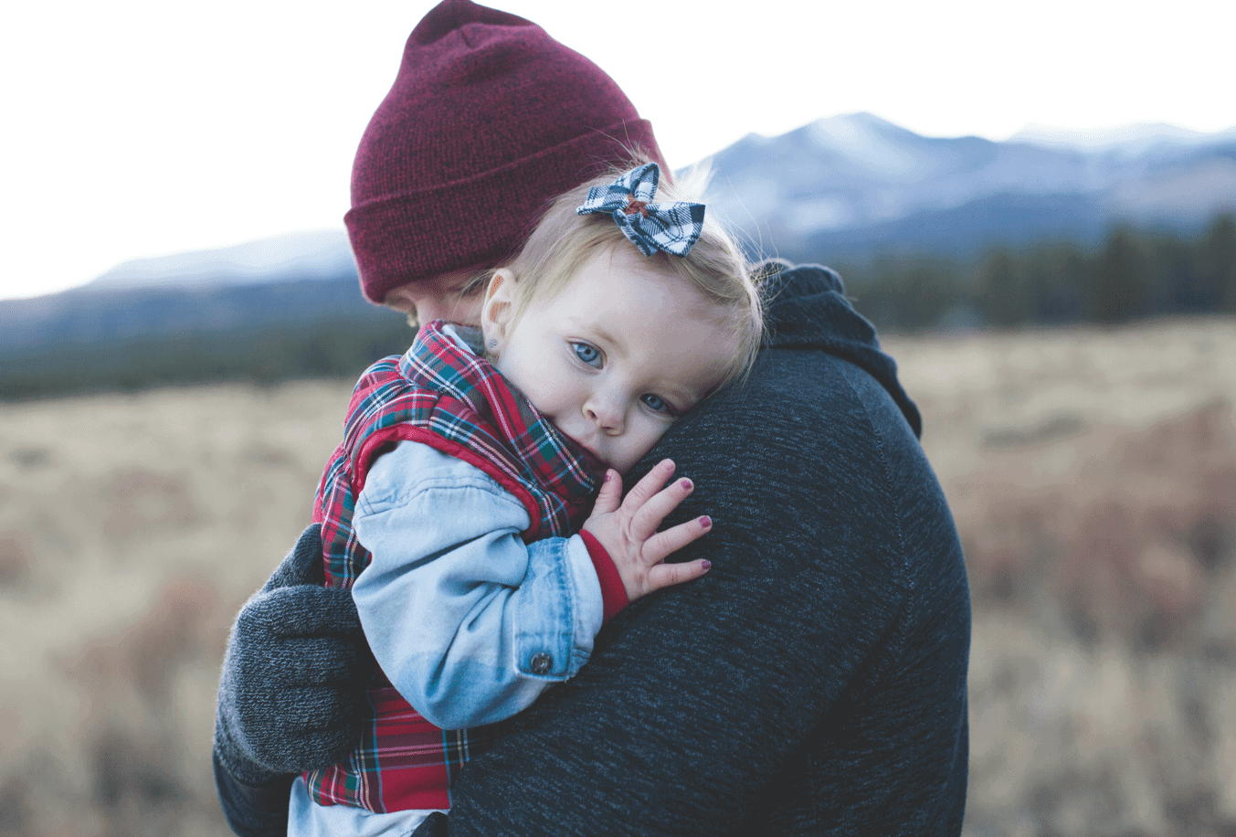 young child hugging their father