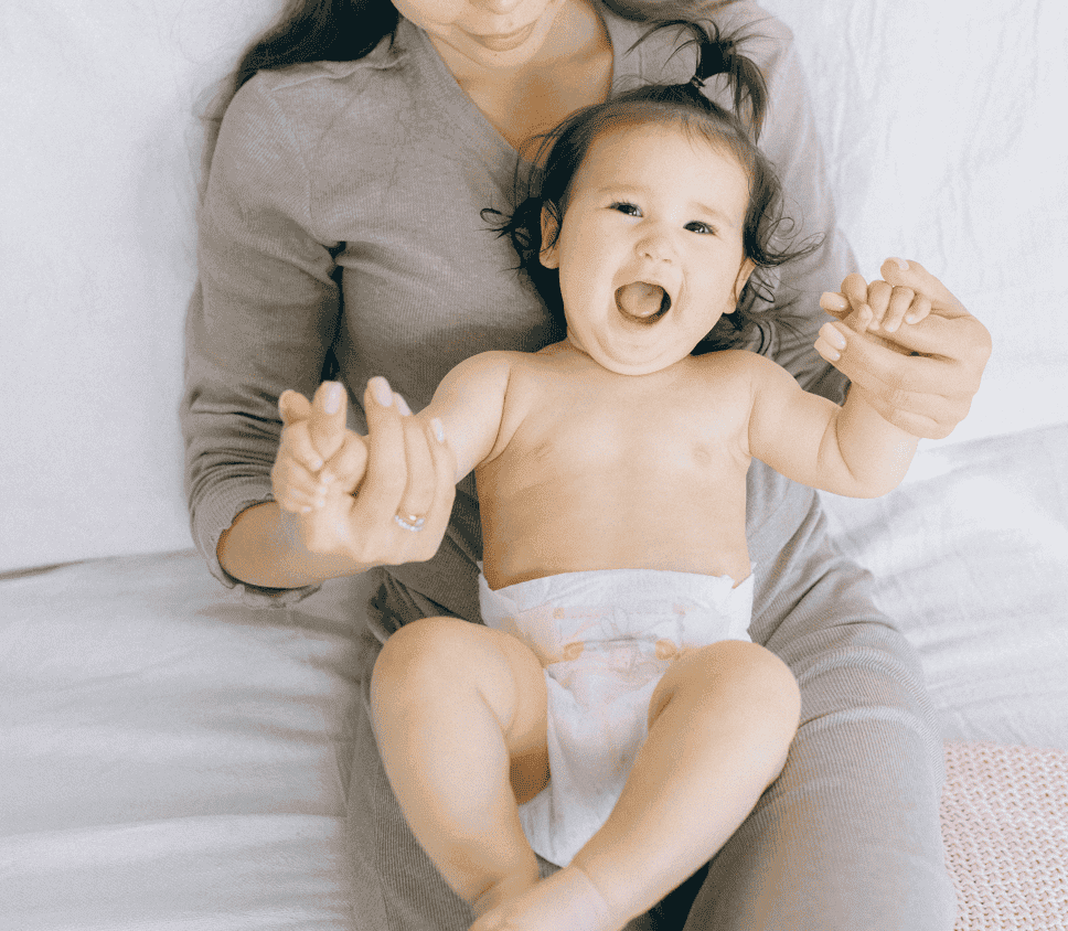 smiling toddler wearing a diaper