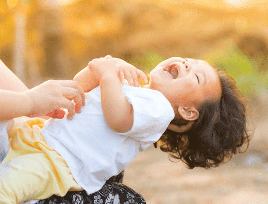 little girl smiling and giggling