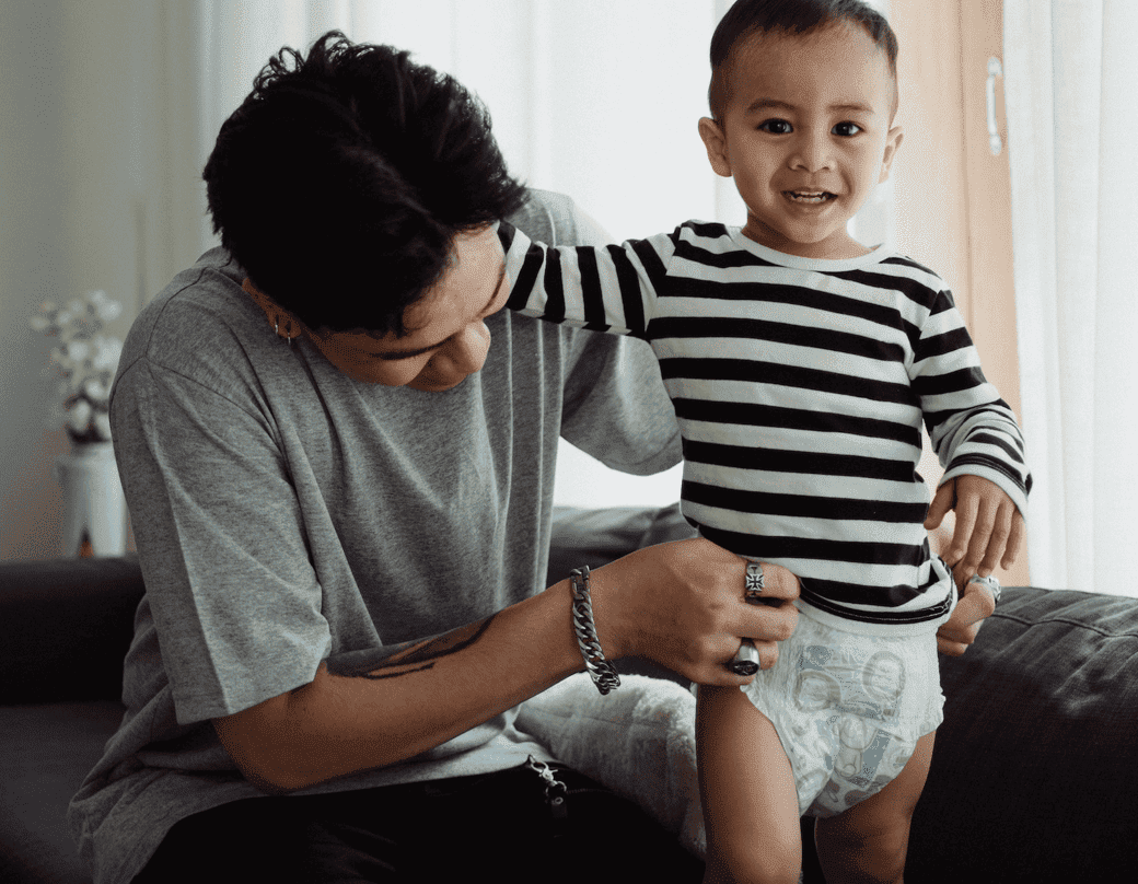 man changing a toddler's diaper
