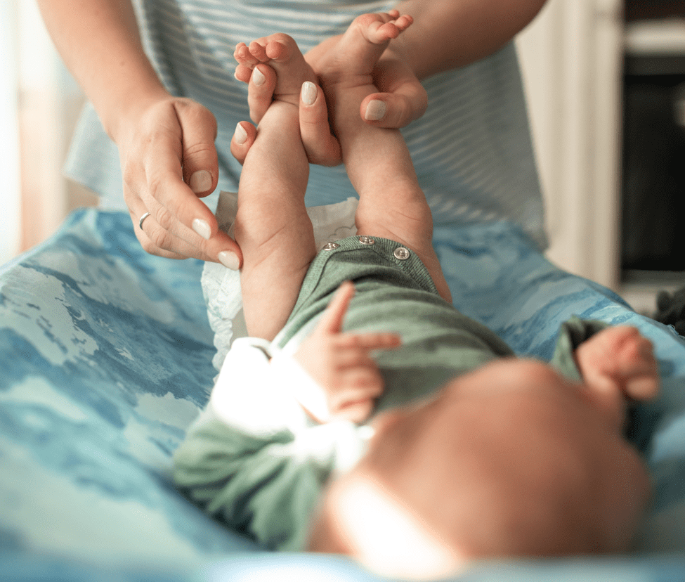 mom changing baby's diaper