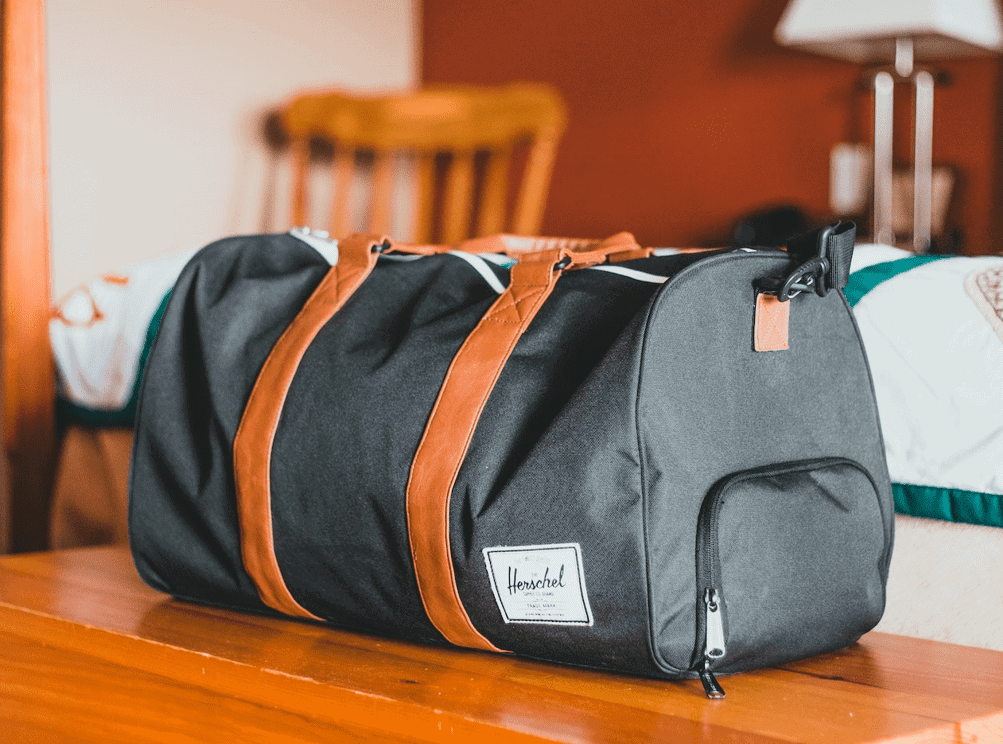 men's duffle bag on table