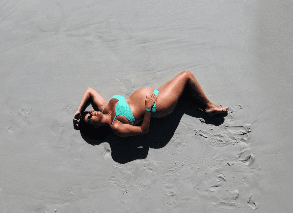 pregnant woman sunbathing on beach