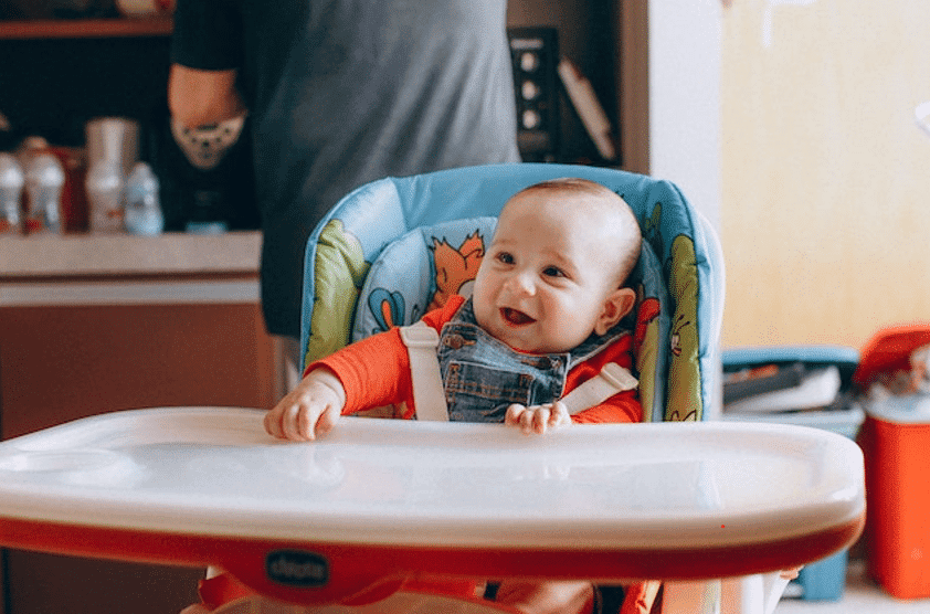 baby sitting on high chair