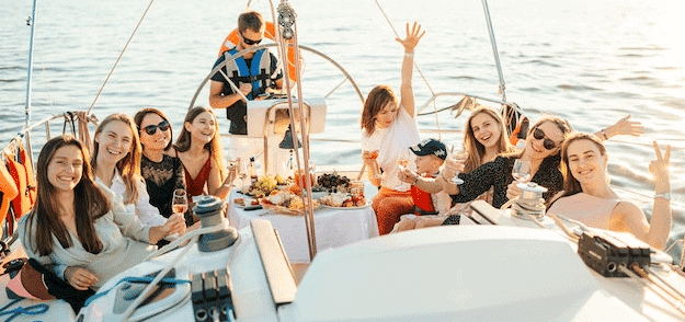 Group of friends sitting on a sail boat