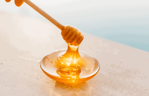 wooden honey dipper stick and bowl