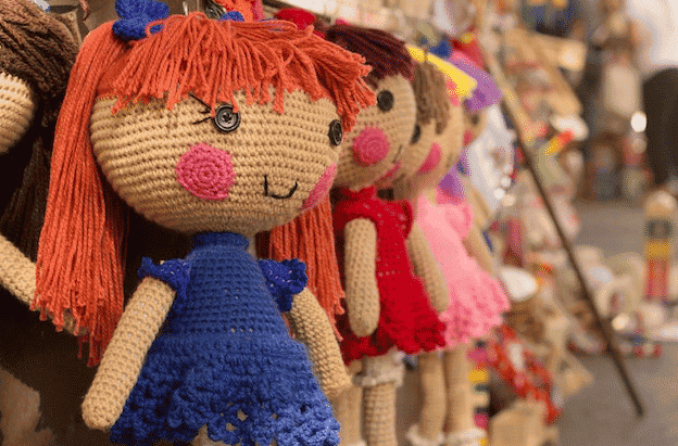 row of dolls in a kid's shop