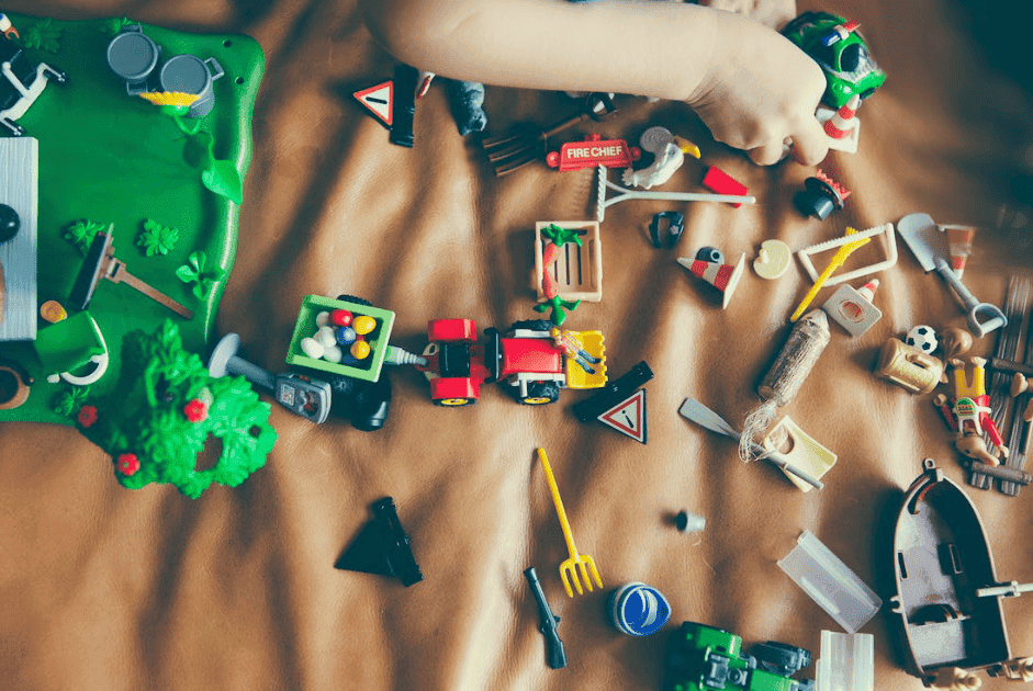 child playing with lots of toys