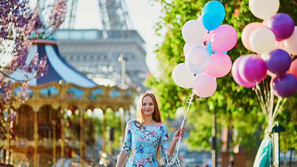 Woman at French festival in France in June holding balloons