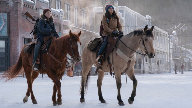Ellie and Dina riding on horseback in the snow in The Last of Us season 2