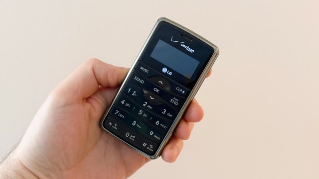 A hand holding the LG enV2 phone