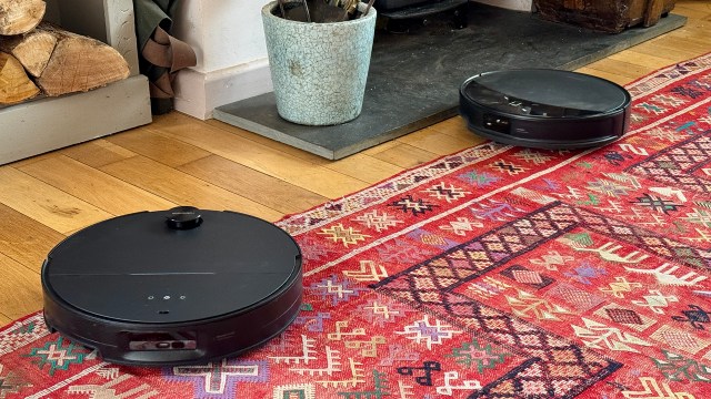 Roborock Saros 10R and Saros 10 robot vacuums side by side in reviewer's house