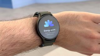 Samsung Galaxy Watch 7 on a wrist showing the Energy score feature