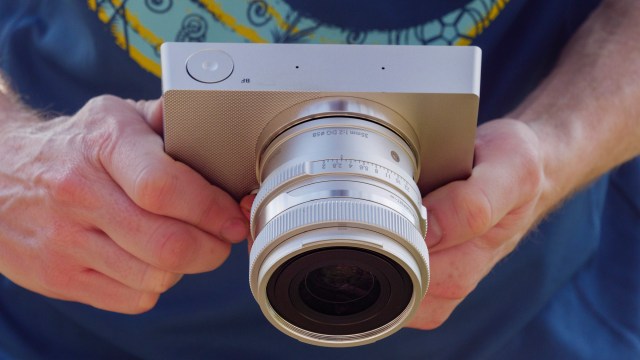 Silver Sigma BF camera with 35mm f/2 DG contemporary lens attached, in the hand