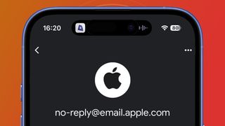 An iPhone on a red background showing a genuine email from Apple