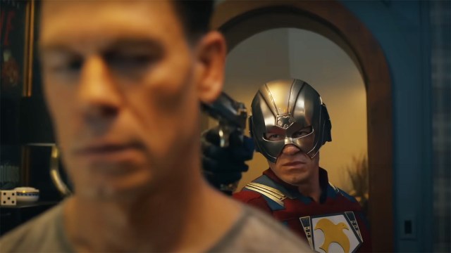 John Cena's Chris Smith being held at gunpoint by a different Chris Smith in Peacemaker season 2