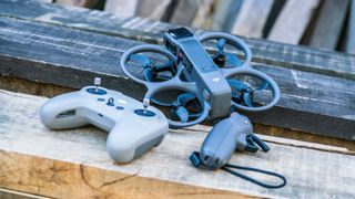 DJI Avata 2 FPV drone with controller and goggles on a wooden bench