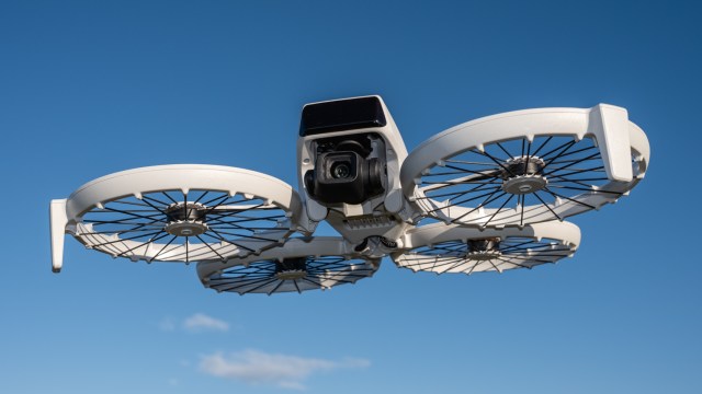 DJI Flip in flight against a blue sky