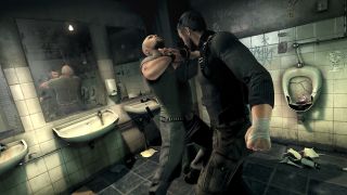 Sam Fisher grapples with a man in a smashed up bathroom
