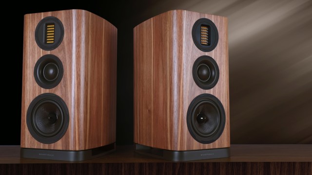 Wharfedale EVO 5 speakers in walnut wood finish against a dark background