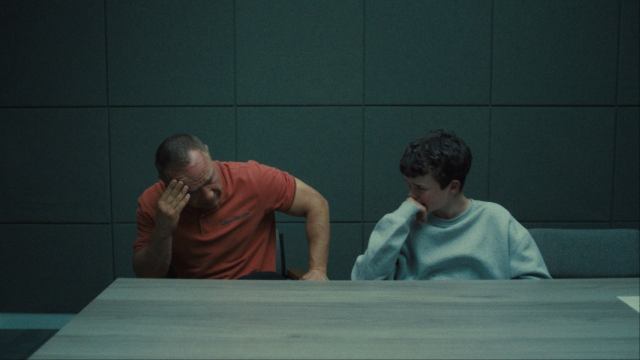 Eddie and Jamie crying in a police interview room in Netflix's Adolescence TV series