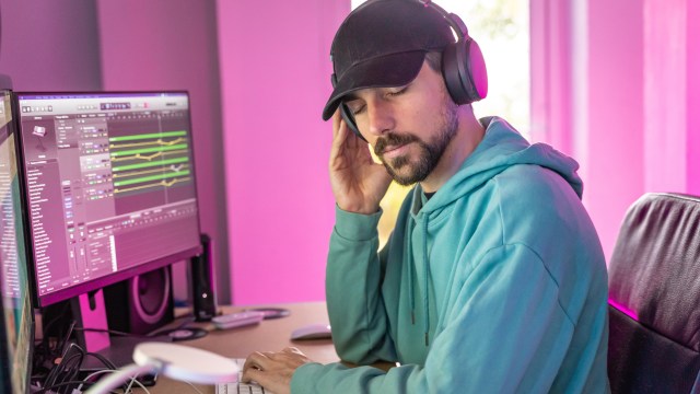 Person listening to music while composing.