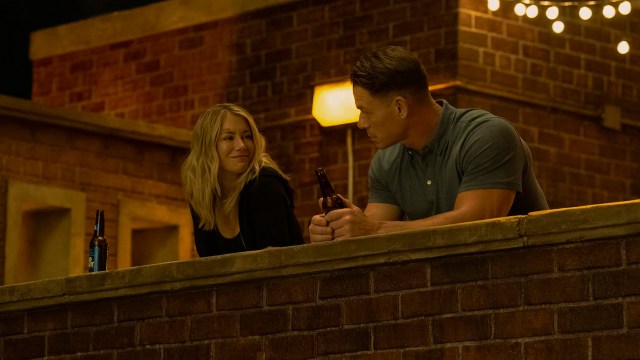 Emilia Harcourt smiling at Chris Smith at night in Peacemaker season 2