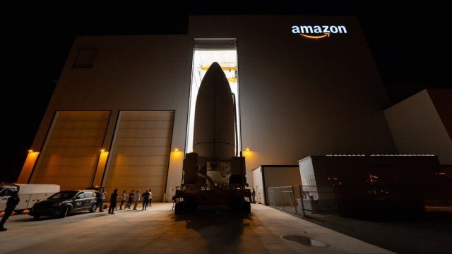 A Project Kuiper rocket in front of an Amazon building