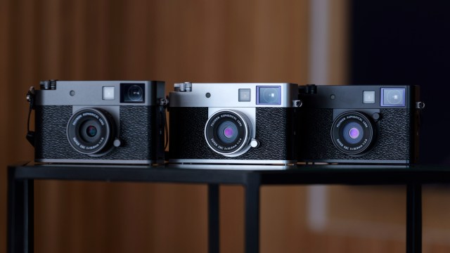 Three Fujifilm X half compact cameras side by side, each a different color