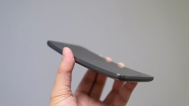 A hand holding the LG G Flex phone