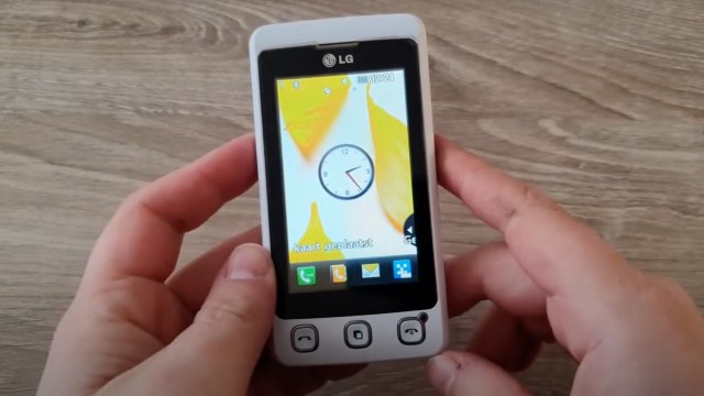 Two hands holding a white LG Cookie KP500
