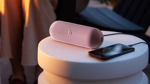 Beats Pill in Blush Pink charging an iPhone