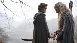 Elrond looks at Galadriel as she glances at her ring Nenya in The Rings of Power season 2