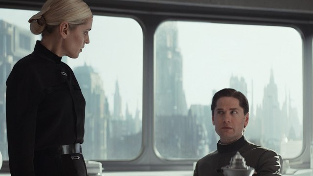 Dedra standing and looking down at a seated Syril in Andor season 2 episode 3