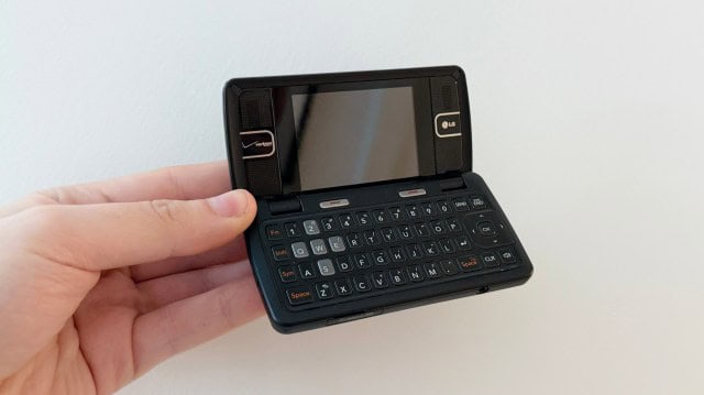 A hand holding the LG enV2 phone