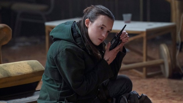 Ellie listening to a walkie-talkie radio in The Last of Us season 2 episode 7
