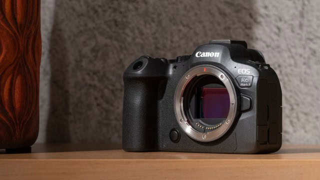The Canon EOS R6 Mark II camera on a wooden shelf