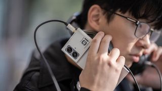 A person holds a phone to their face