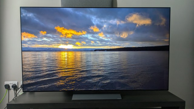 LG C5 with sunset over ocean on screen