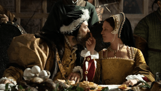 A still from the movie Firebrand showing Alicia Vikander as Katherine Parr and Jude Law as Henry VIII sat at a banquet table