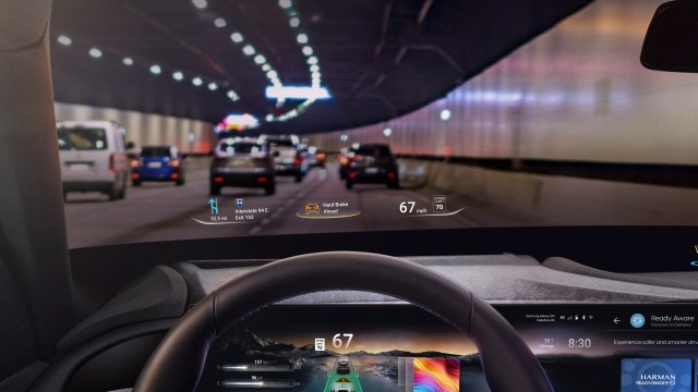 An in-car view showing a steering wheel and Harman's Ready Aware tech on the windshield
